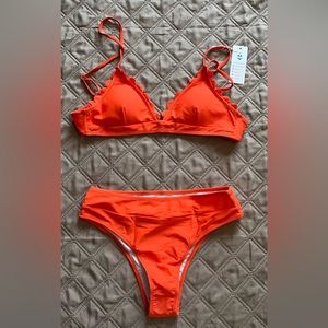 Bikini with high leg and scallop edge around bra.